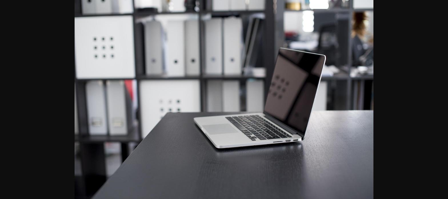 Laptop on a dark office desk
